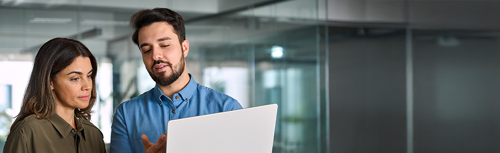 Two solicitors discuss a case query on a laptop