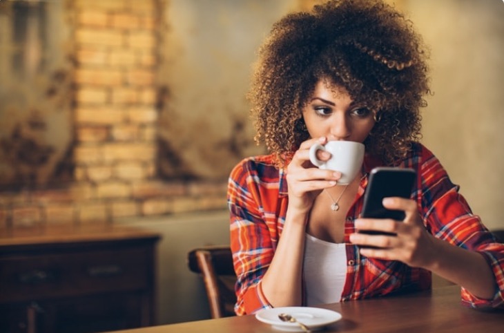 lady on the phone drinking coffee
